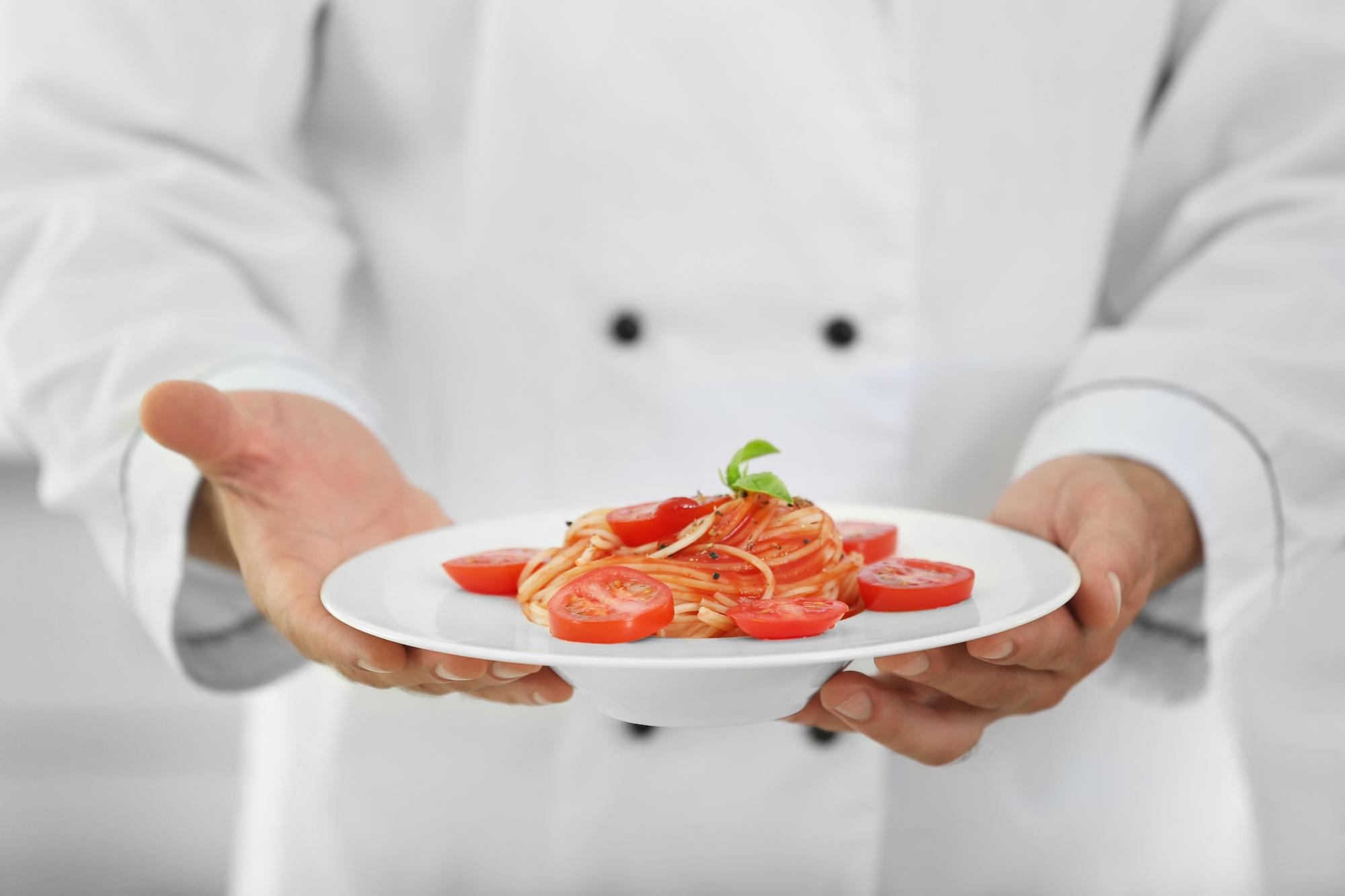 Chef preparing a plated dish with modern plating